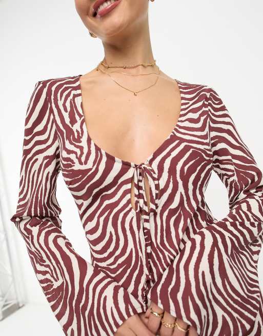Vestidos midi de larga con estampado de cebra y lazada delantera de ASOS DESIGN | ASOS