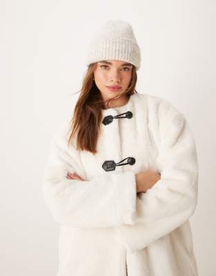 collarless faux fur duffle jacket in cream-White