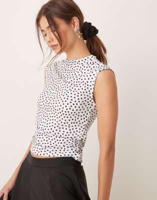 high neck sleeveless ruched top in black and white spots