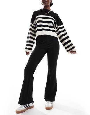 pleat front jersey flared pants in black