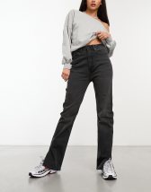 Stradivarius Petite coated flare jean with split hem detail in black