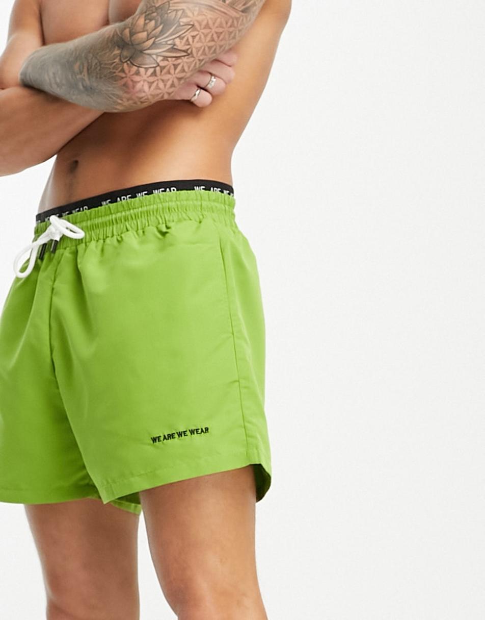 We Are We Wear bobbie standard length swim short with logo waist band in  green