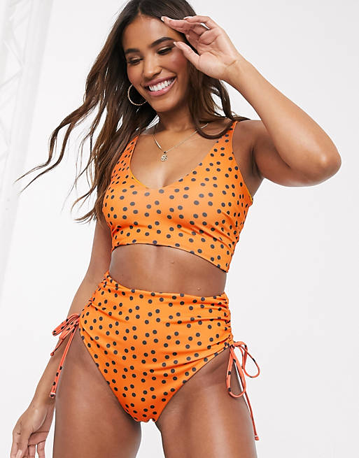 Women We Are We Wear mix and match recycled high waist ruched bikini bottom in orange polka dot 