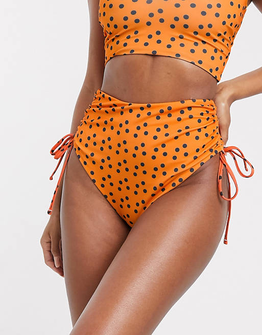 Women We Are We Wear mix and match recycled high waist ruched bikini bottom in orange polka dot 