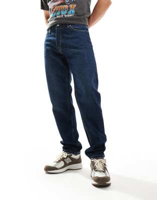 Barrel relaxed fit tapered jeans in compact blue wash