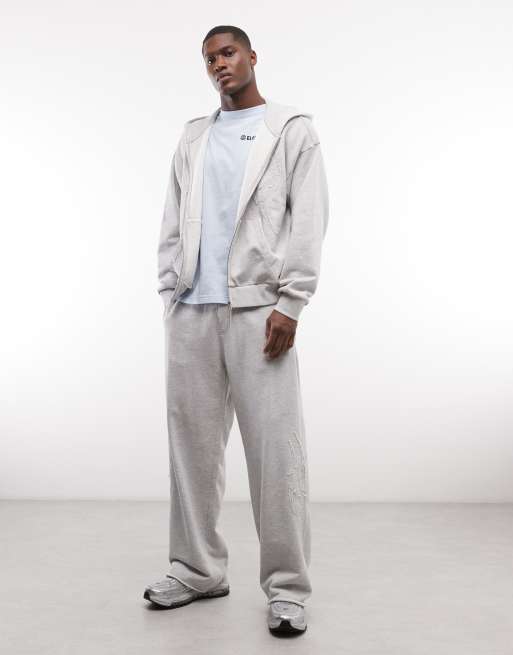 Weekday - Joggers a fondo ampio grigio mélange con dettagli ricamati in coordinato