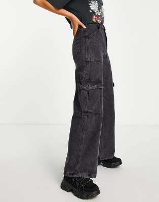 Bershka Petite folded waistband flared trousers in black