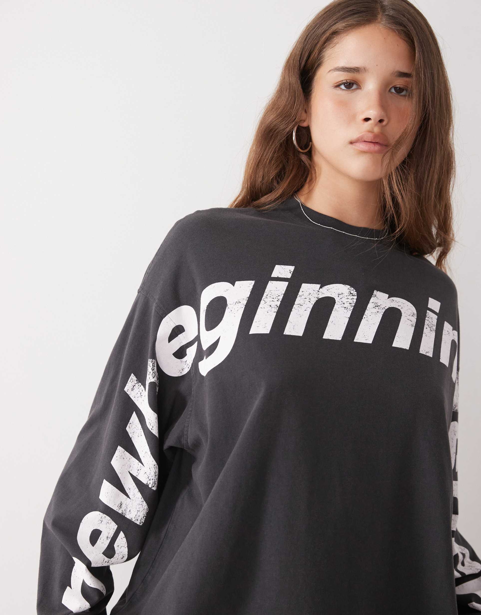 weekday oversized long sleeve t-shirt with new beginning graphic print in off-black