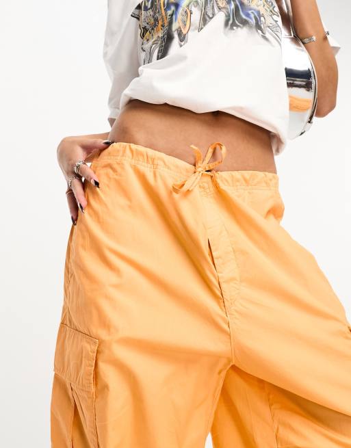 Weekday Unisex parachute baggy pants in orange exclusive to