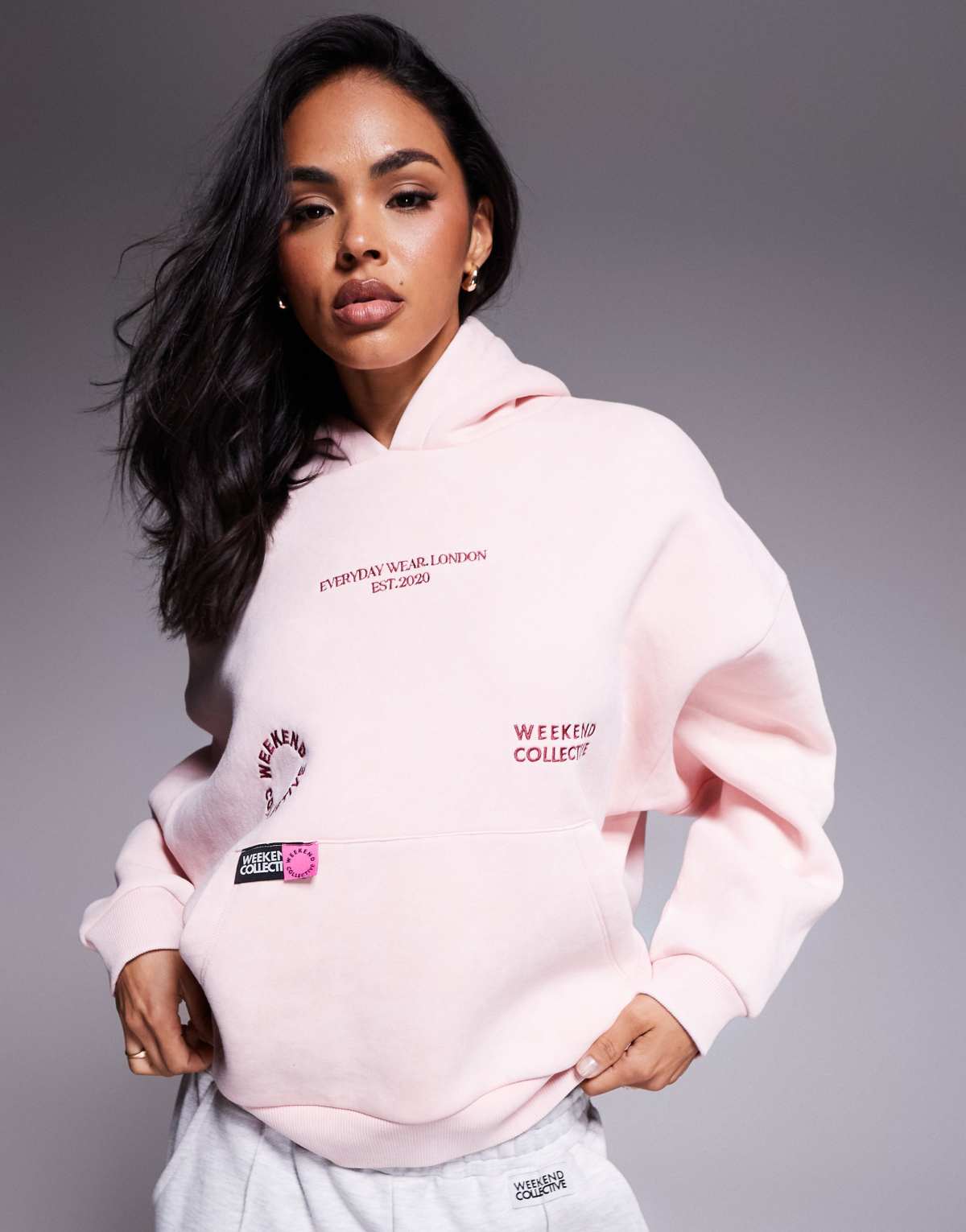 Weekend Collective hoodie with bright pink label detail in washed pink