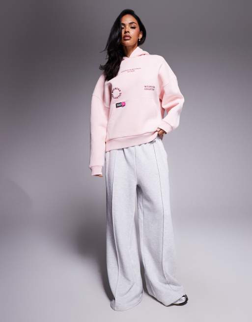 Weekend Collective hoodie with bright pink label detail in washed pink