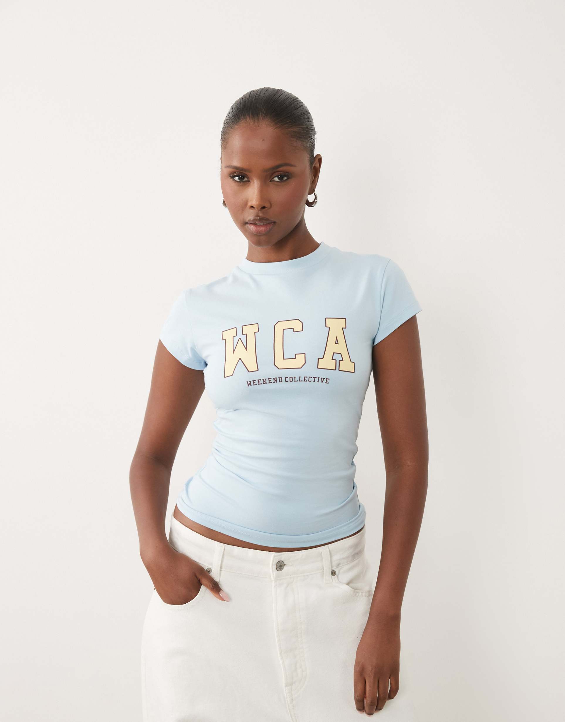 weekend collective icon baby tee with wca graphic in baby blue