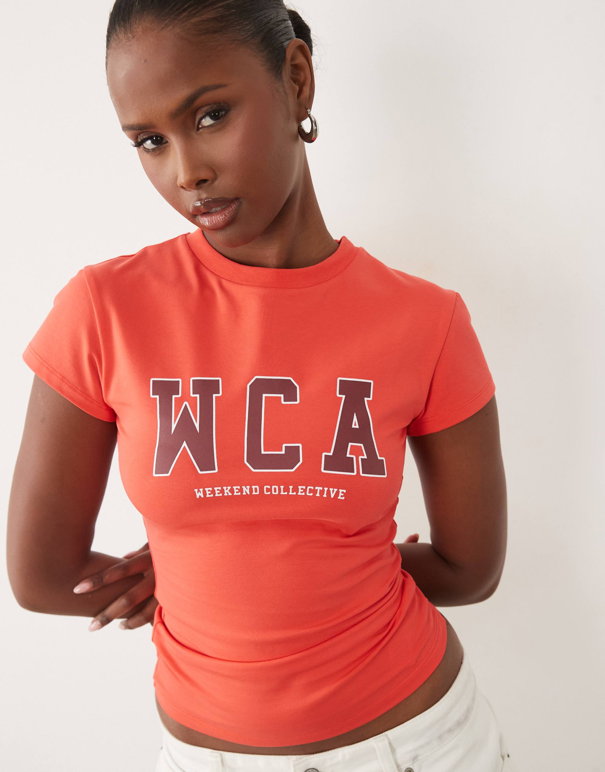 weekend collective icon baby tee with wca graphic in bright red