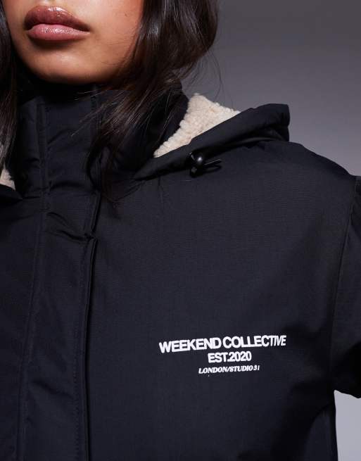 Weekend Collective longline coat with borg lining and graphic in black and cream, 4 of 4