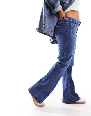 Wrangler Plus super high rise flare jeans with front pockets in mid blue