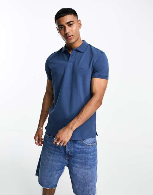 Wrangler solid polo shirt in blue | ASOS