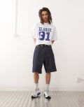 [Xlarge] XLARGE baggy jorts with back pocket OG logo embroidery in rinse-Blue W32 Indigo