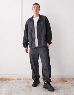 Xlarge XLarge co-ord logo colour block check cuffed tracksuit bottoms in black