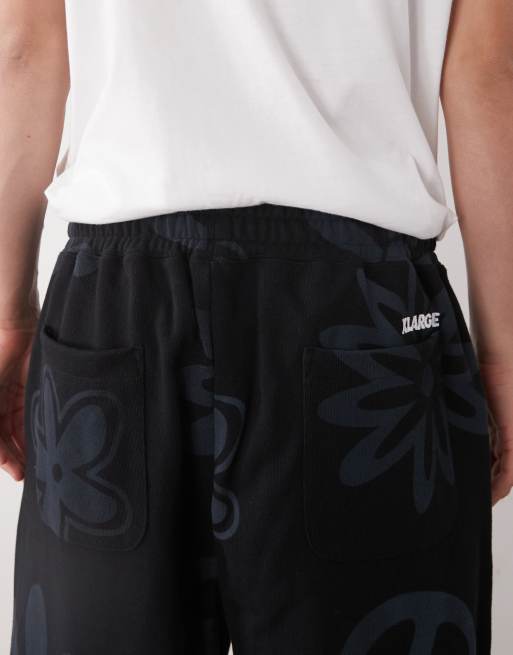 XLARGE peace print logo cuffed joggers co-ord in black, 5 of 5