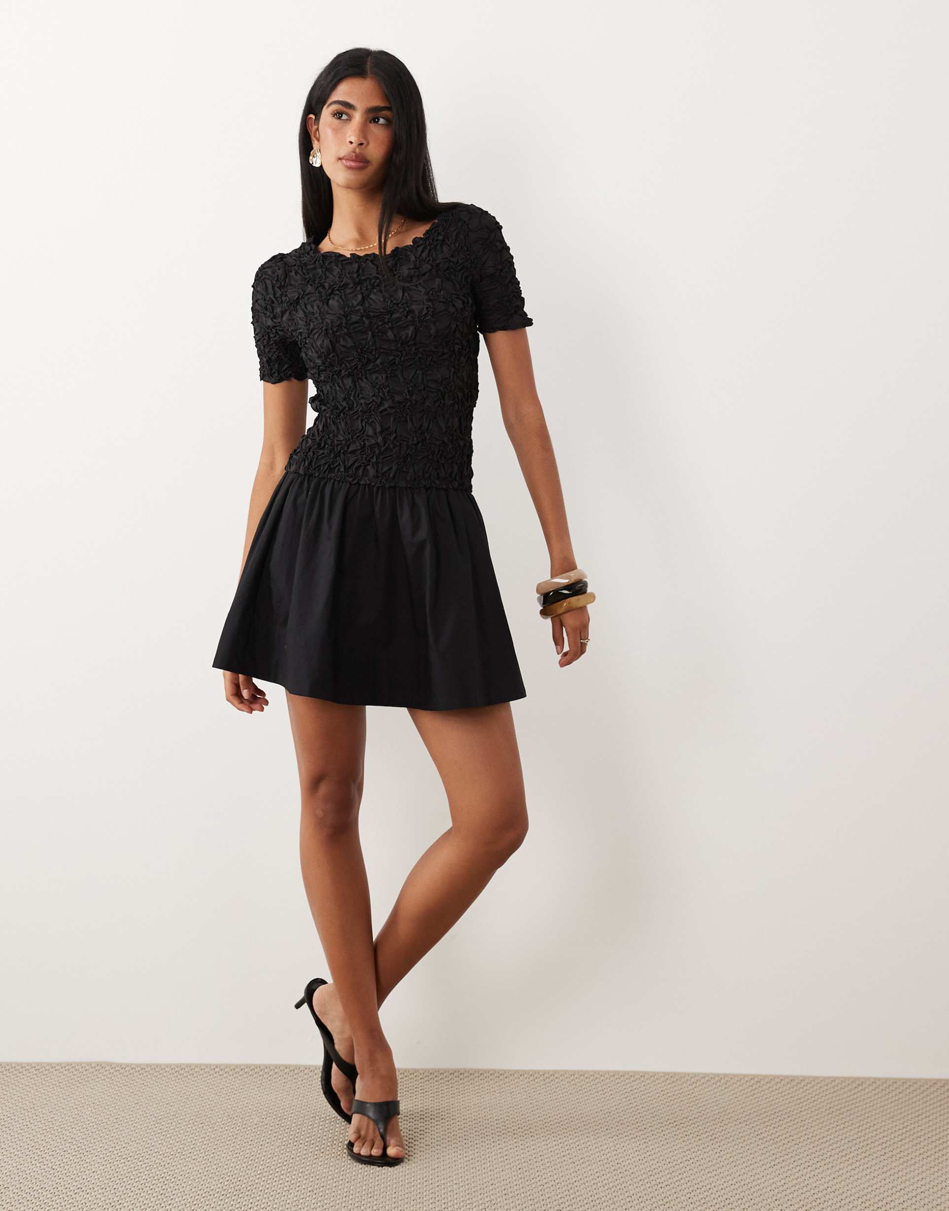 yas 3d textured flippy mini dress in black