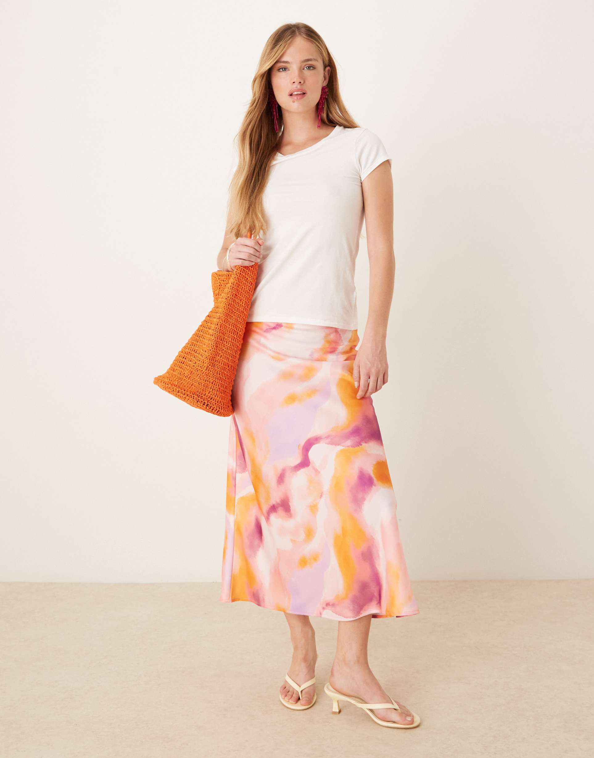 yas blur print midi skirt in pink and orange