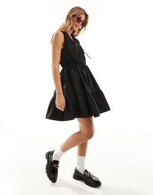 Y.a.s. Cotton Poplin Sleeveless Mini Dress With Ruching And Tie Front Detail In Black