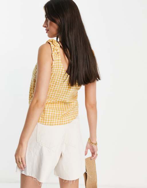 yellow sleeveless blouse