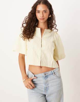 textured blouse with closure detail in pale yellow