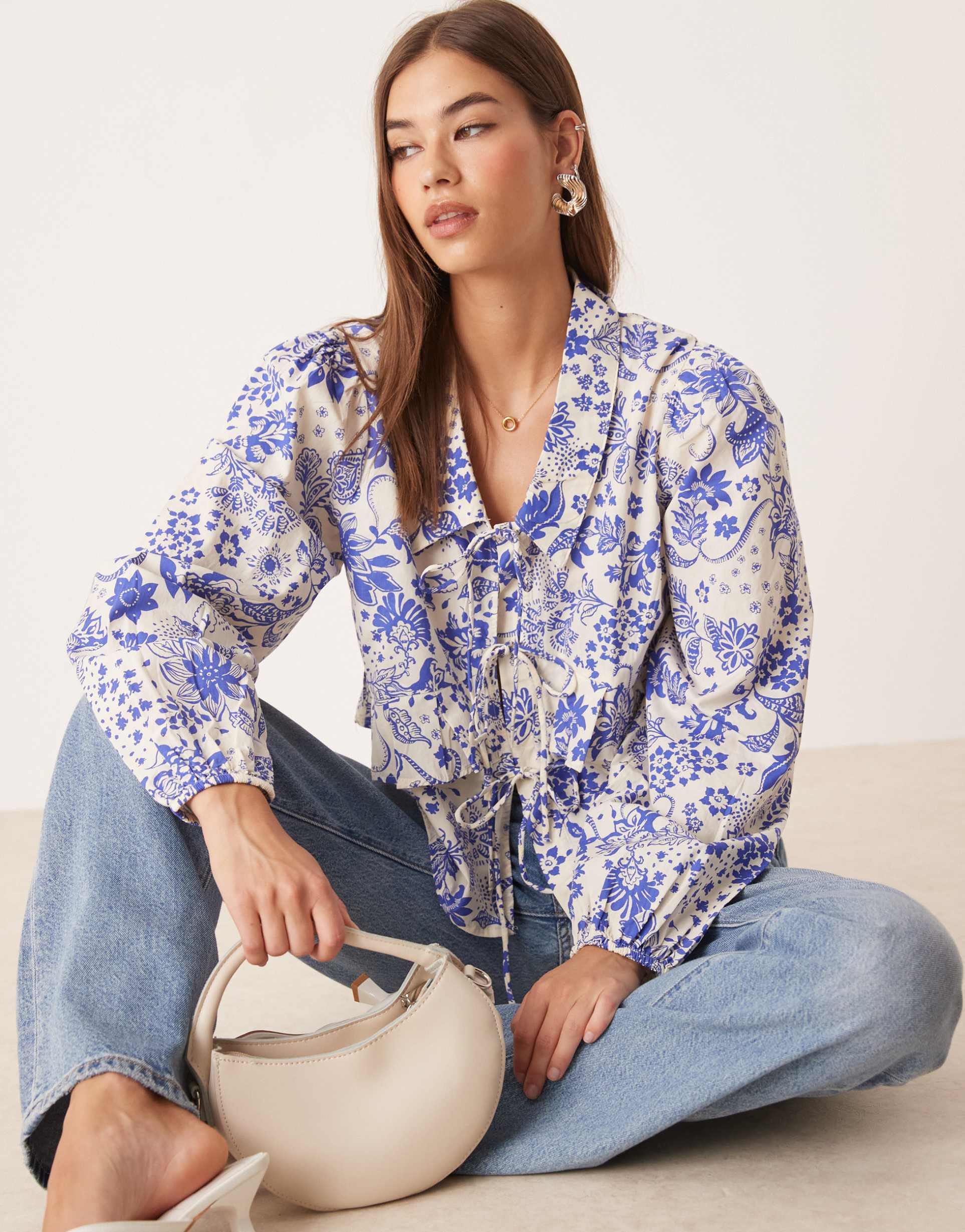 yas tie front ruffle detail top in blue and white paisley floral print