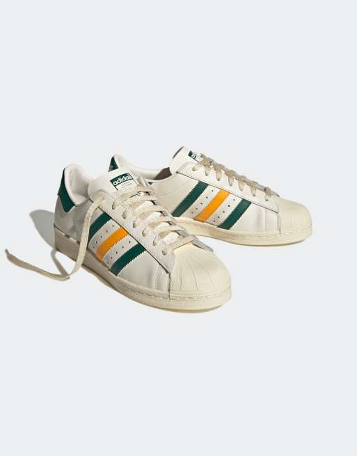 Zapatillas de deporte blancas con amarillas verdes Superstar de adidas | ASOS