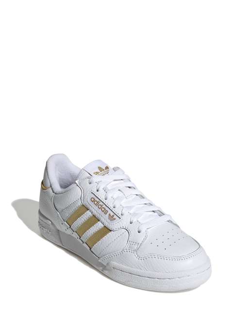 región Extensamente Pantera Zapatillas de deporte blancas con rayas doradas Continental 80 de adidas  Originals | ASOS