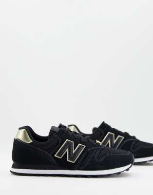 tenis new balance negro con dorado